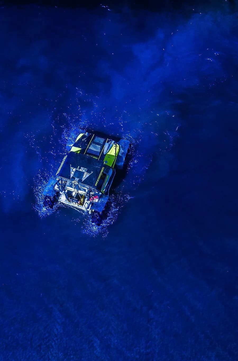 Water Crossing - Extreme offroad rally car crossing the lake, drone photo.